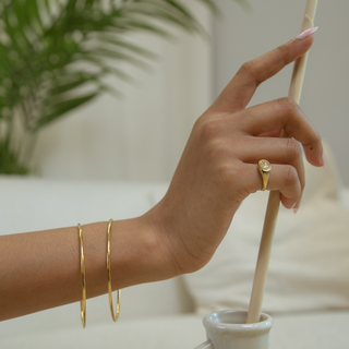 Model wearing gold bangles, showcasing a timeless blend of traditional and modern fashion